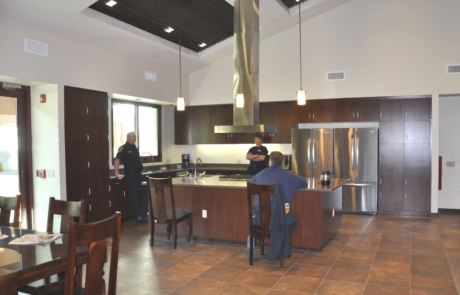 A kitchen with two people sitting at the counter