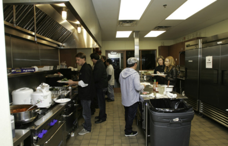 A group of people in a kitchen preparing food.