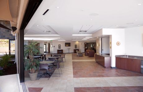 A large lobby with chairs and tables in it