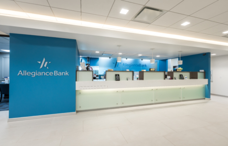 A large bank lobby with blue walls and white counters.