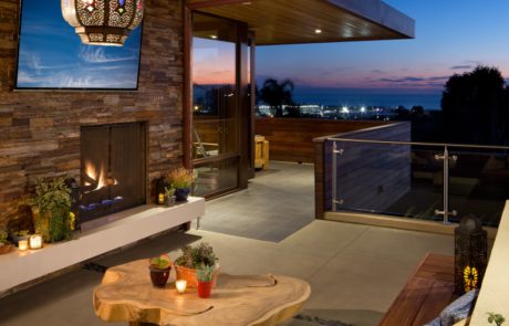 A patio with a fire place and television.