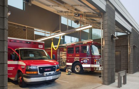 A fire truck and ambulance in an emergency vehicle station.